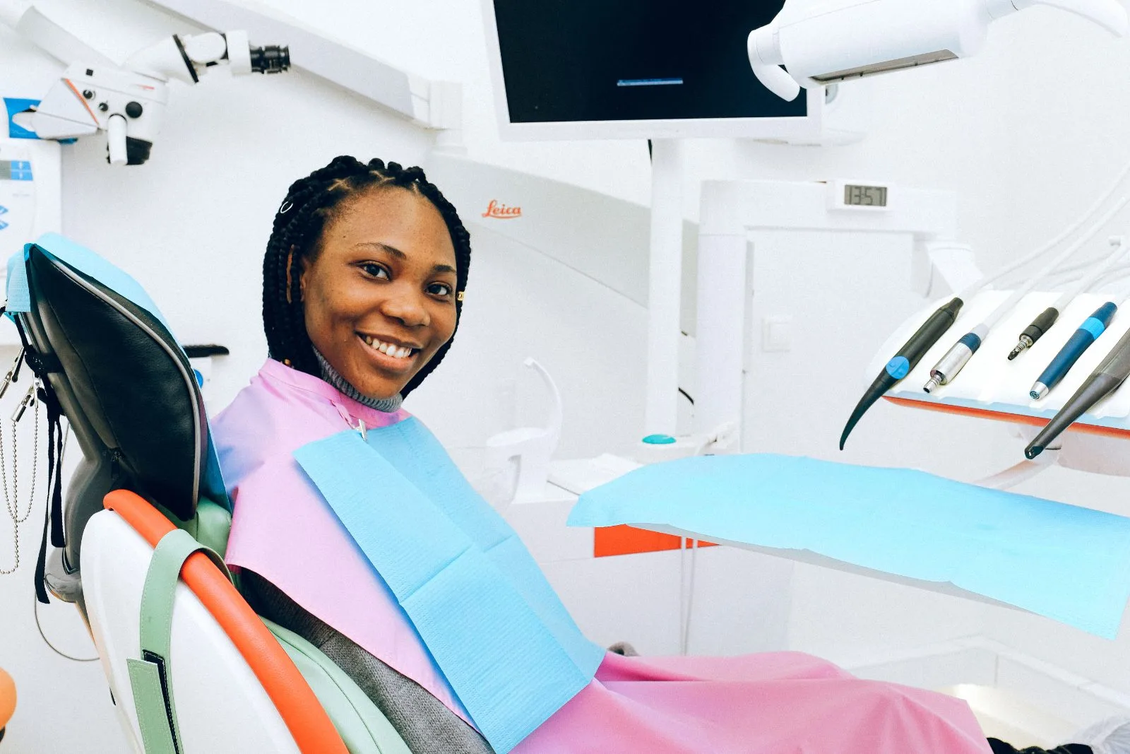 Patient seated in the dental chair, smiling before her appointment