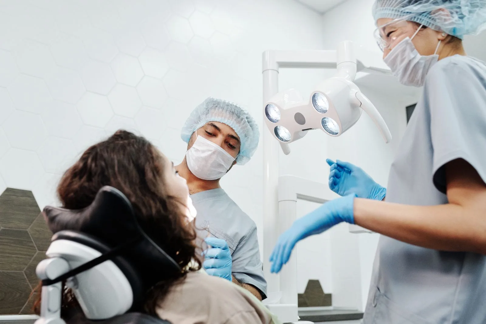 Dentist and assistant working with a patient in the BrightSmile treatment room